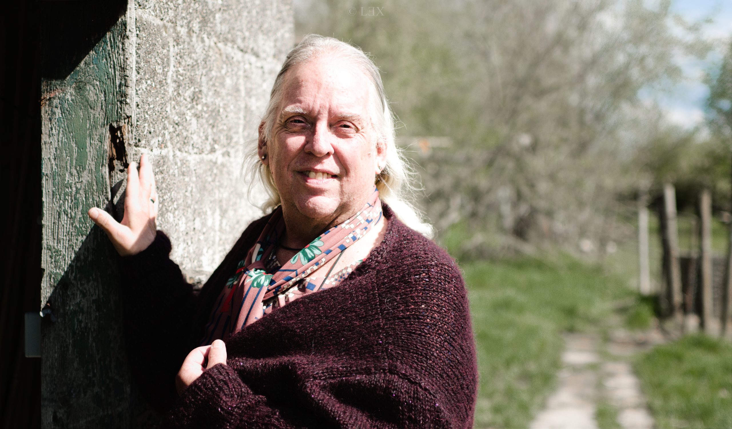 Daíthí standing in their garden, next to the doorway of a shed.